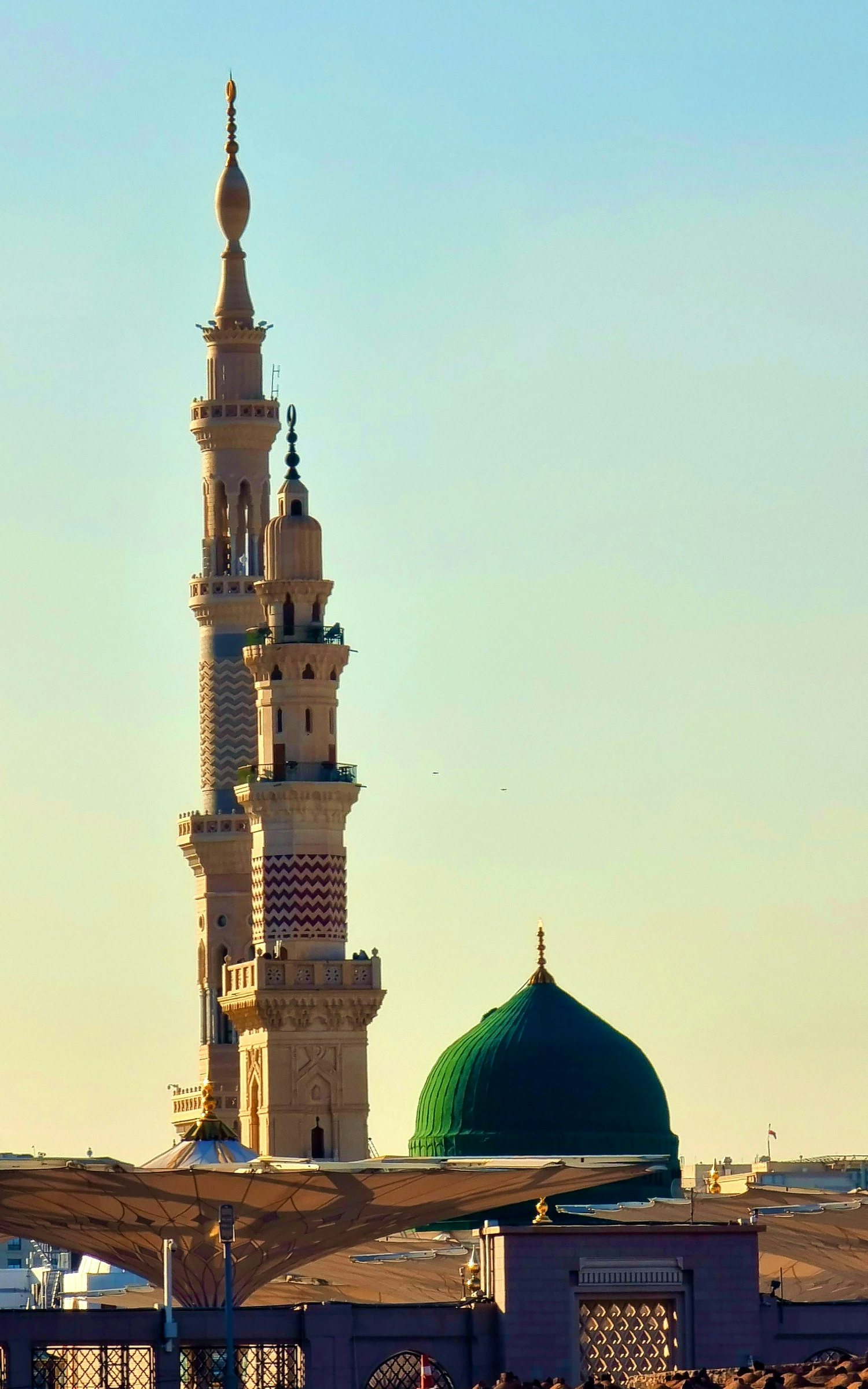 The minarets and Green Dome of Masjid an-Nabawi in Madinah at golden hour